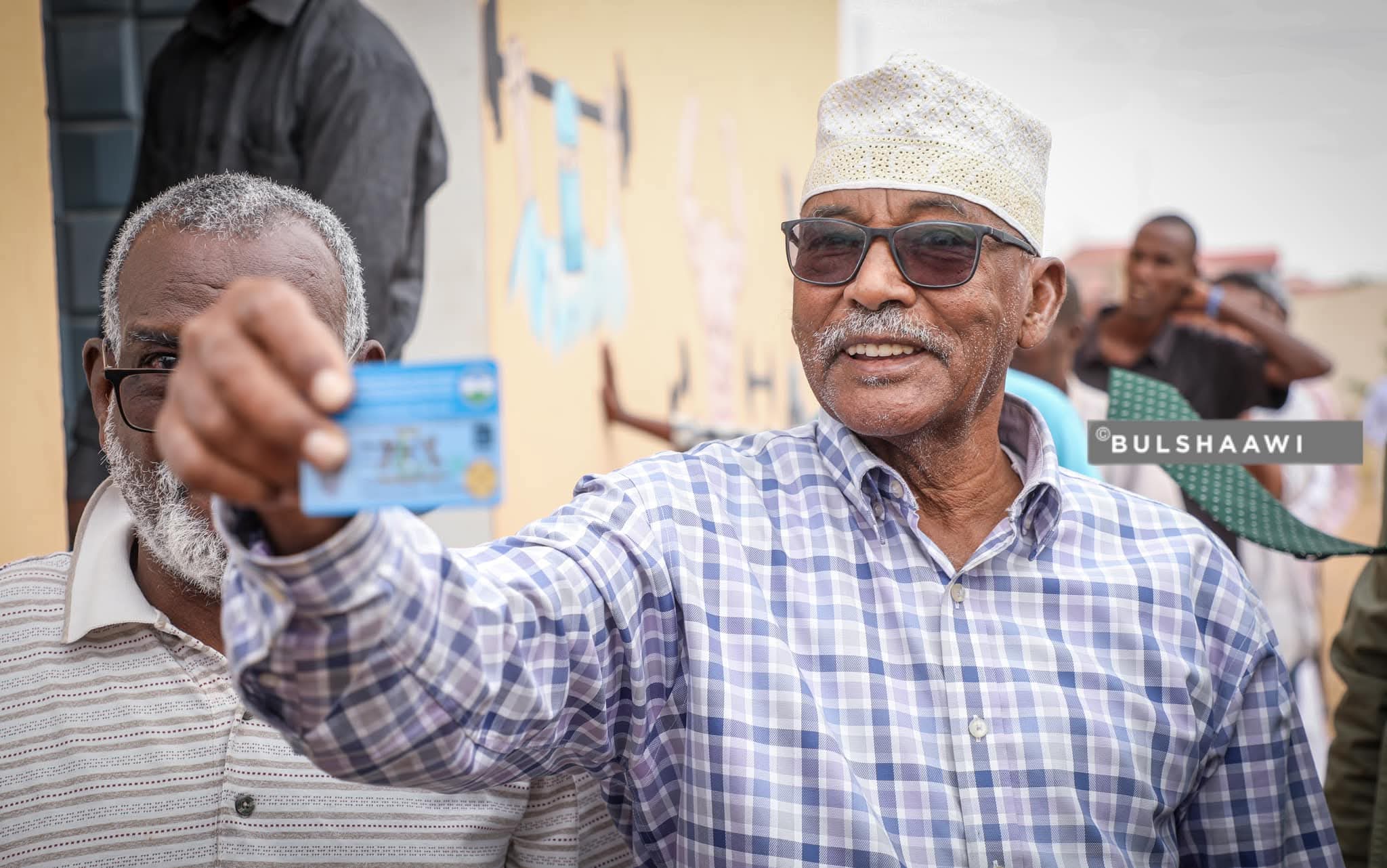 Community elder smiling with membership card